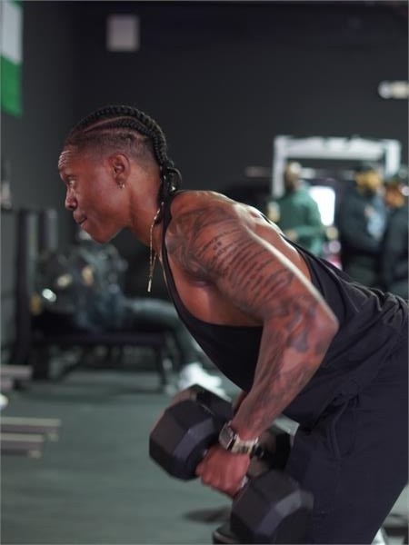 Coach Lex training with a dumbbell